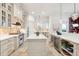 Bright, modern kitchen with a large island, stone tile floors, stainless steel appliances, and ample storage at 3006 Cameron Blvd, Isle of Palms, SC 29451
