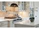 Well-equipped kitchen features a range, custom cabinets, and stone backsplash at 3006 Cameron Blvd, Isle of Palms, SC 29451