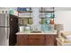 Functional kitchenette with stainless steel appliances and open shelving for dishware and glassware at 3006 Cameron Blvd, Isle of Palms, SC 29451