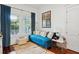 Cozy living room with blue velvet couch, hardwood floors, natural light, and eclectic decor at 3006 Cameron Blvd, Isle of Palms, SC 29451