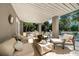 Inviting outdoor lounge area with comfortable seating, stylish decor, and views of the pool and landscaping at 3006 Cameron Blvd, Isle of Palms, SC 29451