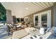Spacious covered patio with ample seating, offering a relaxing outdoor living space with a view of the pool at 3006 Cameron Blvd, Isle of Palms, SC 29451
