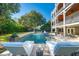 Beautiful in-ground pool with fountain feature and surrounding lounge chairs and patio at 3006 Cameron Blvd, Isle of Palms, SC 29451