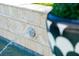 Water feature detail in in-ground pool with fountain spouting water in beautiful backyard at 3006 Cameron Blvd, Isle of Palms, SC 29451