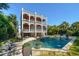 Relax by the pool in this home with multiple decks, outdoor seating, and lush tropical landscaping at 3006 Cameron Blvd, Isle of Palms, SC 29451