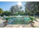 Beautiful in-ground pool with a fountain feature surrounded by lush landscaping at 3006 Cameron Blvd, Isle of Palms, SC 29451