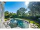Backyard pool with a fountain, surrounded by lush landscaping and lounge chairs, creating a private oasis at 3006 Cameron Blvd, Isle of Palms, SC 29451
