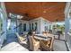Outdoor porch with dining area and spiral staircase leading up to a rooftop patio at 3006 Cameron Blvd, Isle of Palms, SC 29451