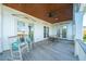 Outdoor porch with rocking chairs, a small bistro set, ceiling fan and three sets of french doors at 3006 Cameron Blvd, Isle of Palms, SC 29451