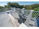 Image showcases a rooftop deck with a spiral staircase leading to views surrounded by lush trees at 3006 Cameron Blvd, Isle of Palms, SC 29451