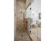 Walk-in shower featuring tile surround, bronze fixtures, and glass partition in bathroom at 3006 Cameron Blvd, Isle of Palms, SC 29451