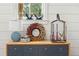 Close-up of a sideboard decorated with a wreath, lighting and decorative items at 3006 Cameron Blvd, Isle of Palms, SC 29451