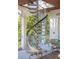 Image highlights a stylish spiral staircase leading to the upper levels of the home at 3006 Cameron Blvd, Isle of Palms, SC 29451