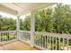 Charming balcony with wood flooring and white railings overlooks lush greenery at 3105 Vanessa Lynne, Johns Island, SC 29455