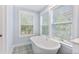 Bright bathroom featuring a standalone tub with patterned floor tiles and natural light at 3105 Vanessa Lynne, Johns Island, SC 29455