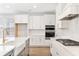 Contemporary kitchen featuring white cabinets, stainless steel appliances, and hardwood floors at 3105 Vanessa Lynne, Johns Island, SC 29455