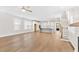 Open-concept living room with hardwood floors leading into a modern kitchen and entryway at 3105 Vanessa Lynne, Johns Island, SC 29455