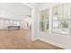 Bright and open living area featuring hardwood floors, white walls, and kitchen with island in the background at 3105 Vanessa Lynne, Johns Island, SC 29455