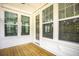Relaxing covered porch area with wood floors and plenty of natural light coming in from the large windows at 3105 Vanessa Lynne, Johns Island, SC 29455