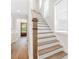 Elegant staircase with hardwood treads, white risers, and natural light from nearby windows at 3105 Vanessa Lynne, Johns Island, SC 29455
