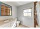 Bathroom with updated vanity, tile flooring, shower with tile surround, and natural light at 328 Fox Field Rd, Walterboro, SC 29488