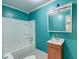 Bathroom with turquoise walls, a bath and shower combo, and a single vanity at 328 Fox Field Rd, Walterboro, SC 29488