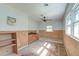 Bedroom featuring wood paneling, a ceiling fan, and bright natural light at 328 Fox Field Rd, Walterboro, SC 29488