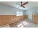 Bedroom featuring wood paneling, carpet flooring, and a ceiling fan at 328 Fox Field Rd, Walterboro, SC 29488
