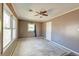 A neutral bedroom features a ceiling fan and natural light from the windows at 328 Fox Field Rd, Walterboro, SC 29488
