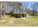 Exterior view of a single-story house featuring a front porch, a well-maintained lawn and a partially fenced yard at 328 Fox Field Rd, Walterboro, SC 29488