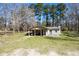 Front exterior view of house with covered porch and lush trees in the front yard at 328 Fox Field Rd, Walterboro, SC 29488