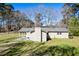 Back exterior view of a cozy home surrounded by trees and a well-manicured lawn at 328 Fox Field Rd, Walterboro, SC 29488