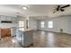 Spacious living room connected to the kitchen area, featuring hard surface flooring and a ceiling fan at 328 Fox Field Rd, Walterboro, SC 29488