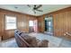 Cozy living room features wood paneling, a ceiling fan, and a comfortable couch at 328 Fox Field Rd, Walterboro, SC 29488