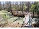 Backyard creek with algae on water with wooden bridge over the water at 328 Fox Field Rd, Walterboro, SC 29488