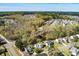 Aerial view of home surrounded by mature trees and a pond in a quiet neighborhood at 329 Carriage Wheel Rd, Moncks Corner, SC 29461