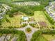 Aerial view of community amenities including a pool, playground, sports fields, and green spaces at 329 Carriage Wheel Rd, Moncks Corner, SC 29461