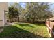 Spacious backyard featuring a wooden fence, mature trees, and a lush lawn, perfect for outdoor activities at 329 Carriage Wheel Rd, Moncks Corner, SC 29461