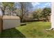 Well-maintained backyard with a storage shed, expansive lawn, and privacy fence at 329 Carriage Wheel Rd, Moncks Corner, SC 29461
