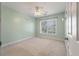 Bedroom featuring carpet, a ceiling fan, and a large window overlooking a yard at 329 Carriage Wheel Rd, Moncks Corner, SC 29461