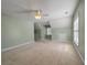 Large bedroom featuring neutral carpeting, multiple windows, and access to attic storage at 329 Carriage Wheel Rd, Moncks Corner, SC 29461
