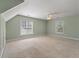 Spacious bedroom with carpet, a ceiling fan, and two large windows overlooking a yard at 329 Carriage Wheel Rd, Moncks Corner, SC 29461