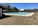 Resort-style community pool with a sun deck, shaded structures, and meticulously manicured landscaping at 329 Carriage Wheel Rd, Moncks Corner, SC 29461