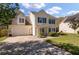 Charming two-story home with a attached two car garage and lovely blue shutters at 329 Carriage Wheel Rd, Moncks Corner, SC 29461