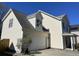 Side view of a two-story home showcasing the garage and light-colored vinyl siding at 329 Carriage Wheel Rd, Moncks Corner, SC 29461