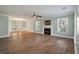 Bright living room with fireplace, hardwood floors, and windows overlooking a yard at 329 Carriage Wheel Rd, Moncks Corner, SC 29461