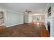 Bright living room with a cozy fireplace and wood-look tile floors at 329 Carriage Wheel Rd, Moncks Corner, SC 29461