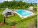 Aerial view of community pool with lounge chairs, a covered picnic area, and green space at 329 Carriage Wheel Rd, Moncks Corner, SC 29461