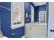 Stylish blue bathroom with white marble vanity, bright window, and tasteful decor at 382 Race St # A, Charleston, SC 29403