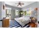 Bright bedroom with hardwood floors, a ceiling fan, and access to the porch at 382 Race St # A, Charleston, SC 29403